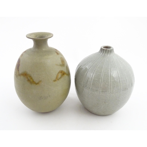 188 - A studio pottery vase with a flared rim and stylised floral detail. Together with a vase of globular... 