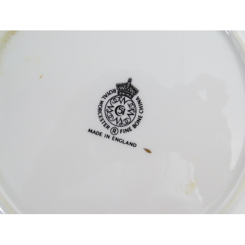 198 - Seven Royal Worcester armorial plates to include two bearing the Cambridge University coat of arms, ... 