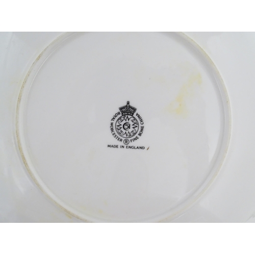 198 - Seven Royal Worcester armorial plates to include two bearing the Cambridge University coat of arms, ... 