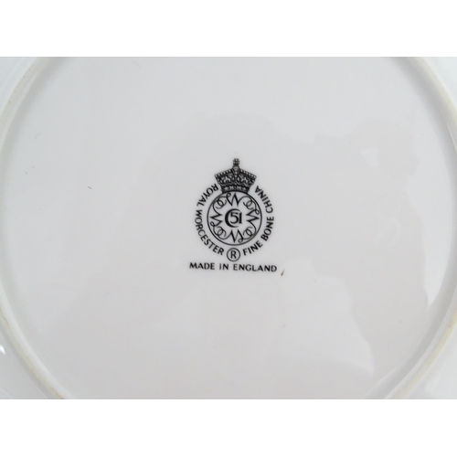 198 - Seven Royal Worcester armorial plates to include two bearing the Cambridge University coat of arms, ... 