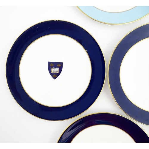 198 - Seven Royal Worcester armorial plates to include two bearing the Cambridge University coat of arms, ... 