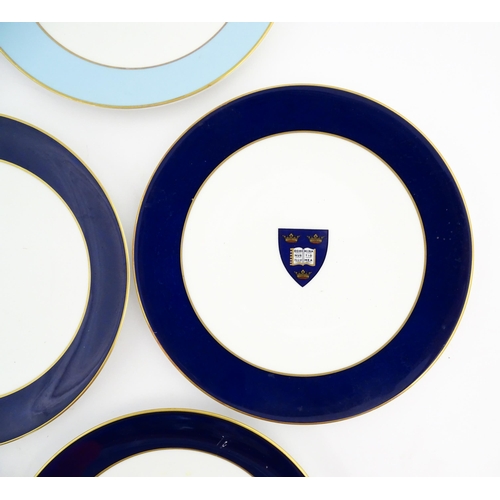 198 - Seven Royal Worcester armorial plates to include two bearing the Cambridge University coat of arms, ... 