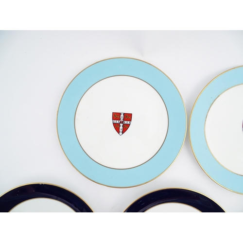 198 - Seven Royal Worcester armorial plates to include two bearing the Cambridge University coat of arms, ... 