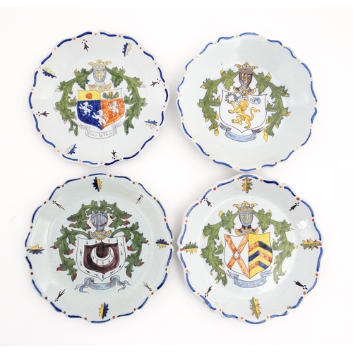 209 - Four Continental faience plates each decorated with a hand painted armorial. Approx. 10