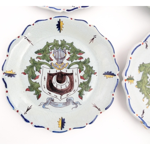 209 - Four Continental faience plates each decorated with a hand painted armorial. Approx. 10