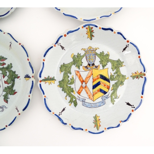 209 - Four Continental faience plates each decorated with a hand painted armorial. Approx. 10