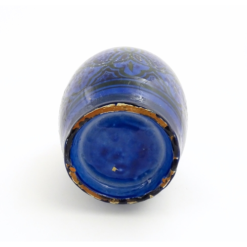 222 - A Moroccan terracotta vase the blue ground decorated with repeating motifs. Approx. 12 3/4