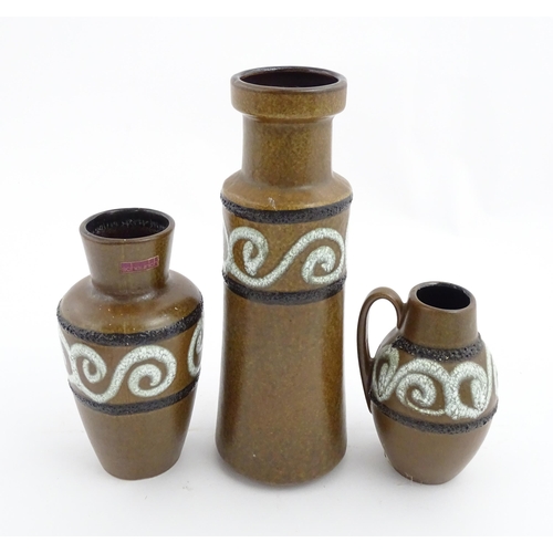 233 - A set of three West German Scheurich vases with brown glaze and banded swirl detail. Marked under an... 