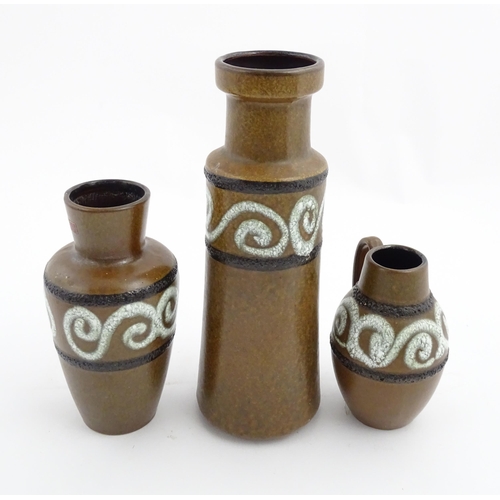 233 - A set of three West German Scheurich vases with brown glaze and banded swirl detail. Marked under an... 