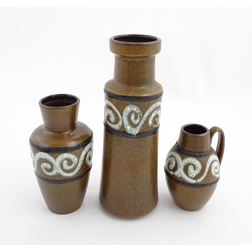 233 - A set of three West German Scheurich vases with brown glaze and banded swirl detail. Marked under an... 