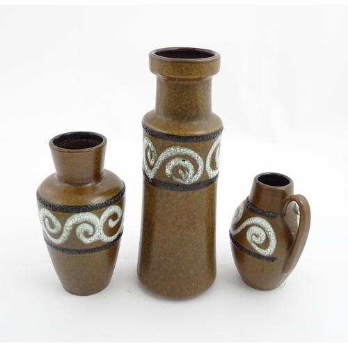 233 - A set of three West German Scheurich vases with brown glaze and banded swirl detail. Marked under an... 