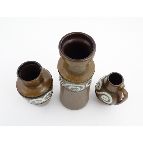 233 - A set of three West German Scheurich vases with brown glaze and banded swirl detail. Marked under an... 