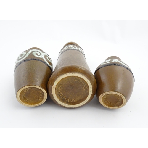 233 - A set of three West German Scheurich vases with brown glaze and banded swirl detail. Marked under an... 