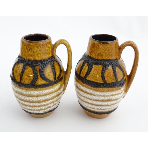 234 - A pair of West German Scheurich vases with single handle and banded decoration. Marked under and num... 