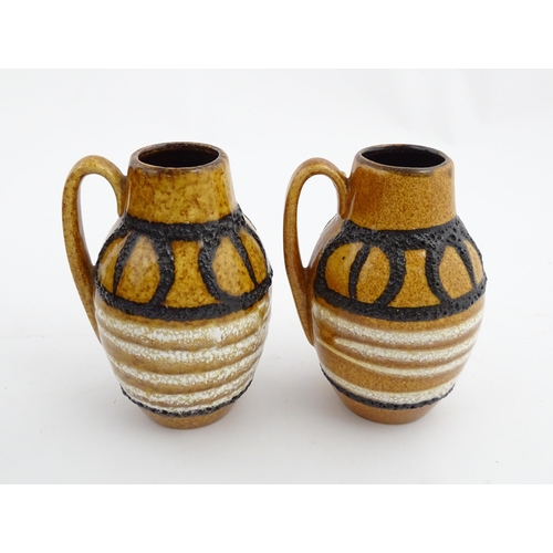 234 - A pair of West German Scheurich vases with single handle and banded decoration. Marked under and num... 