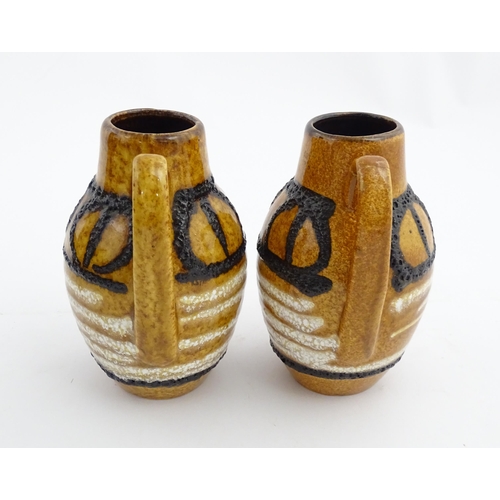 234 - A pair of West German Scheurich vases with single handle and banded decoration. Marked under and num... 