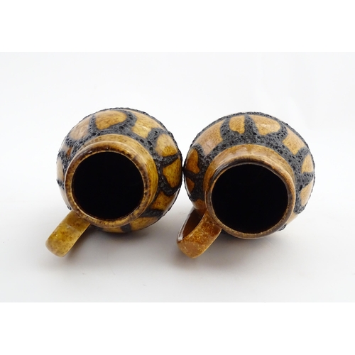 234 - A pair of West German Scheurich vases with single handle and banded decoration. Marked under and num... 