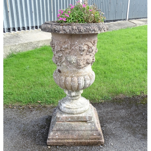 823 - Garden / Architectural: a large 19thC ornate stone urn planter, of classical form with fruiting vine... 