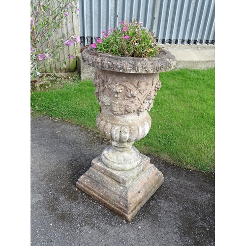 823 - Garden / Architectural: a large 19thC ornate stone urn planter, of classical form with fruiting vine... 