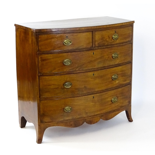 1439 - A 19thC bow fronted mahogany chest of drawers comprising two short over three long drawers raised on... 