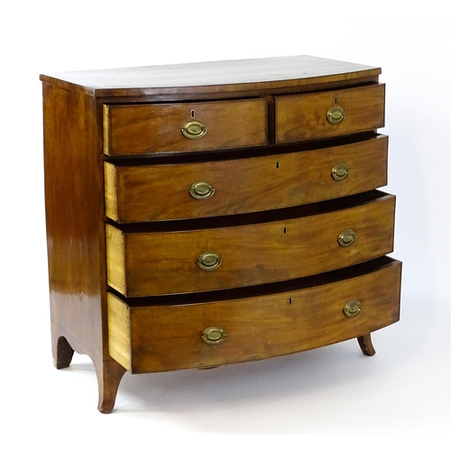 1439 - A 19thC bow fronted mahogany chest of drawers comprising two short over three long drawers raised on... 