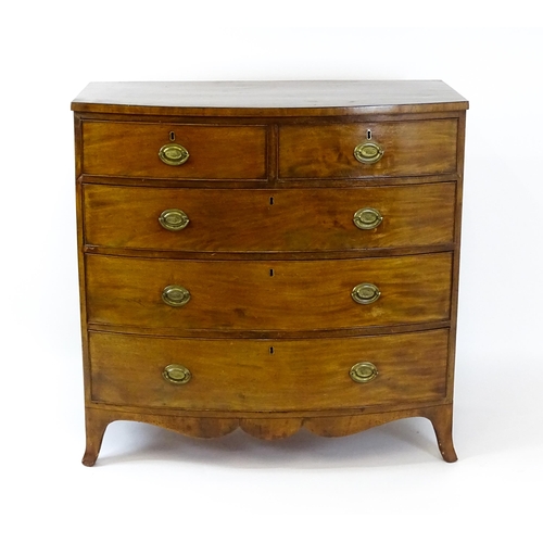 1439 - A 19thC bow fronted mahogany chest of drawers comprising two short over three long drawers raised on... 