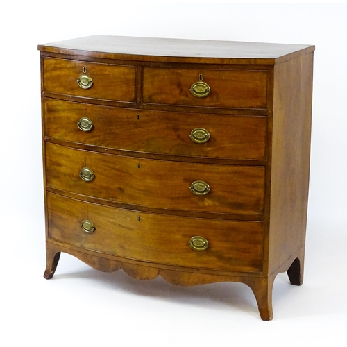 1439 - A 19thC bow fronted mahogany chest of drawers comprising two short over three long drawers raised on... 