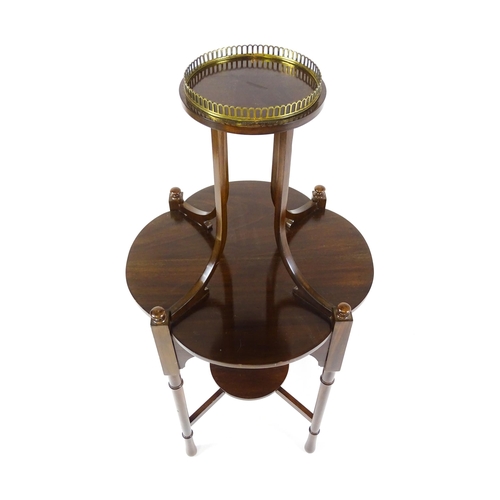 1440 - An Edwardian mahogany centre table, having a circular upper tier with a brass galley raised on four ... 