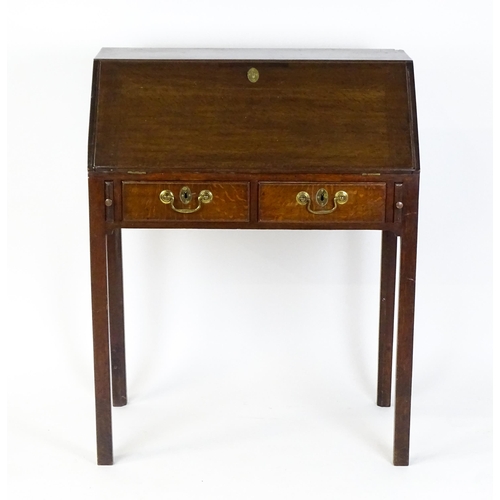 1562 - A late 18thC oak clerks desk with a fall front above two short drawers with swan neck handles and ra... 