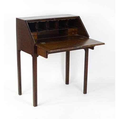 1562 - A late 18thC oak clerks desk with a fall front above two short drawers with swan neck handles and ra... 