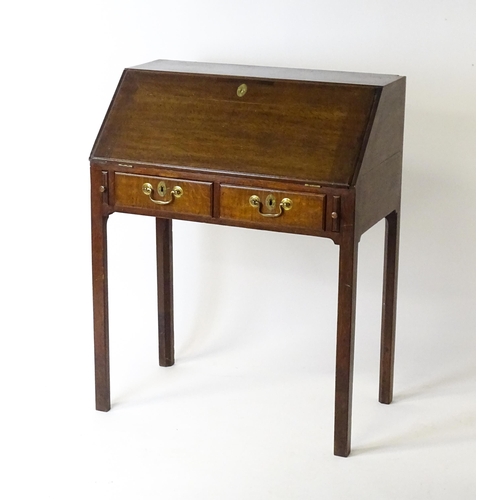 1562 - A late 18thC oak clerks desk with a fall front above two short drawers with swan neck handles and ra... 