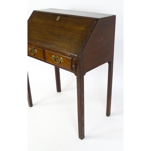 1562 - A late 18thC oak clerks desk with a fall front above two short drawers with swan neck handles and ra... 