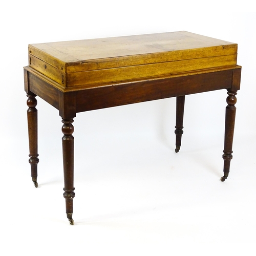 1563 - A Victorian bagatelle on stand raised on four turned tapering legs terminating in brass castors. 50