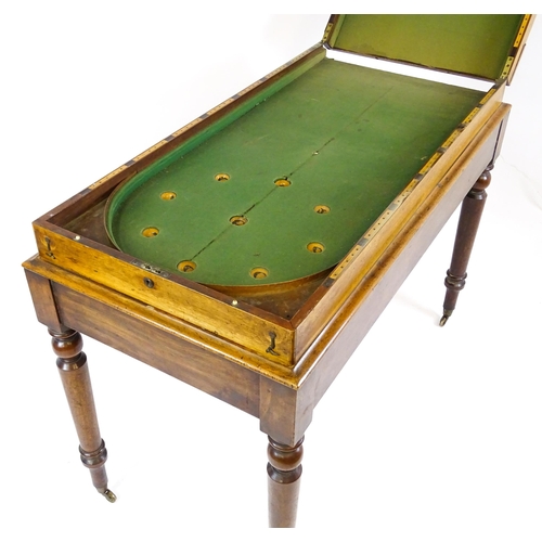 1563 - A Victorian bagatelle on stand raised on four turned tapering legs terminating in brass castors. 50