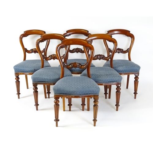 1571 - A set of six Victorian mahogany dining chairs with balloon backs, carved mid rails and raised on tur... 