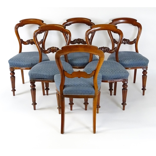 1571 - A set of six Victorian mahogany dining chairs with balloon backs, carved mid rails and raised on tur... 