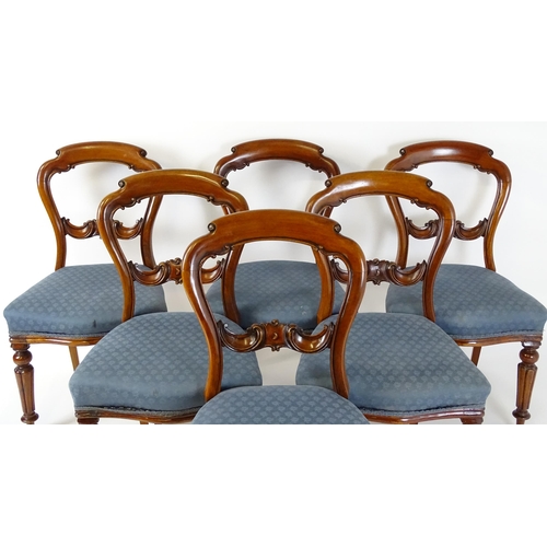 1571 - A set of six Victorian mahogany dining chairs with balloon backs, carved mid rails and raised on tur... 