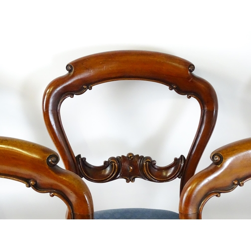 1571 - A set of six Victorian mahogany dining chairs with balloon backs, carved mid rails and raised on tur... 