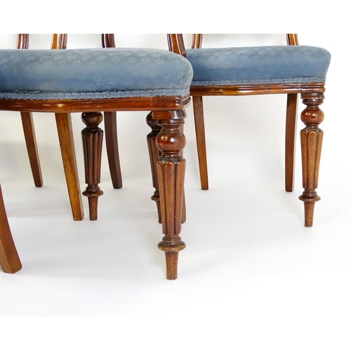 1571 - A set of six Victorian mahogany dining chairs with balloon backs, carved mid rails and raised on tur... 