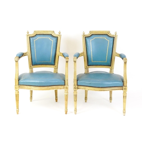 1574 - A pair of 20thC French Louis XVI armchairs, surmounted by turned finials and having gold tooled leat... 