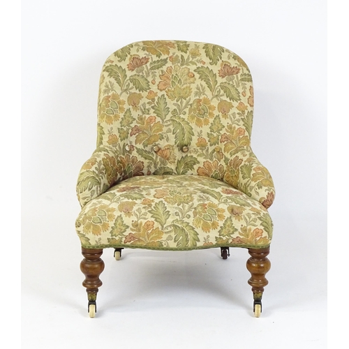 1578 - A mid / late 19thC nursing chair with floral upholstery raised on turned tapering legs terminating i... 