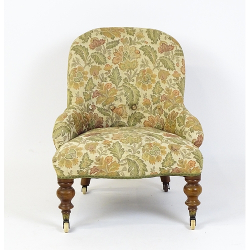 1578 - A mid / late 19thC nursing chair with floral upholstery raised on turned tapering legs terminating i... 