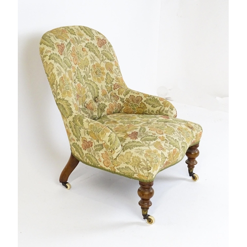 1578 - A mid / late 19thC nursing chair with floral upholstery raised on turned tapering legs terminating i... 