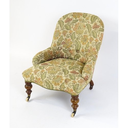 1578 - A mid / late 19thC nursing chair with floral upholstery raised on turned tapering legs terminating i... 