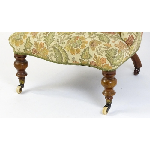 1578 - A mid / late 19thC nursing chair with floral upholstery raised on turned tapering legs terminating i... 