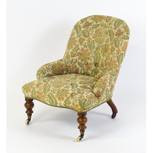 1578 - A mid / late 19thC nursing chair with floral upholstery raised on turned tapering legs terminating i... 