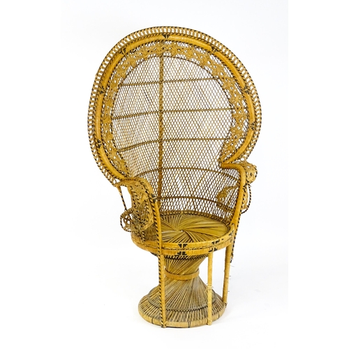 1585 - A 20thC peacock chair of rattan construction. 37