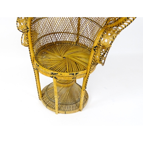 1585 - A 20thC peacock chair of rattan construction. 37