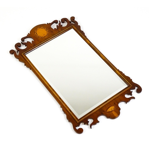 1586 - A Regency style yew wood veneered wall mirror inlaid with marquetry decoration. 20