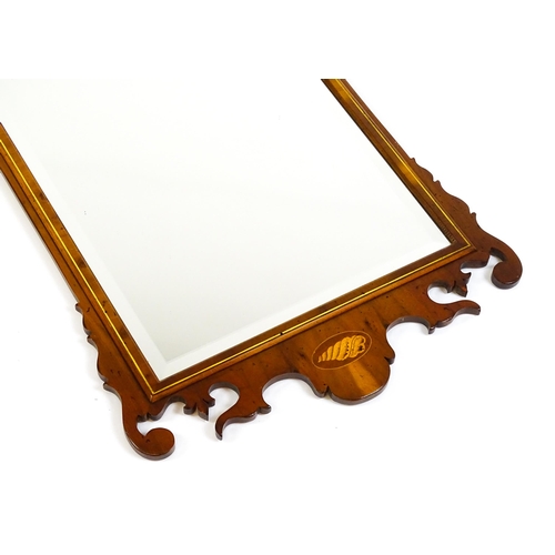 1586 - A Regency style yew wood veneered wall mirror inlaid with marquetry decoration. 20